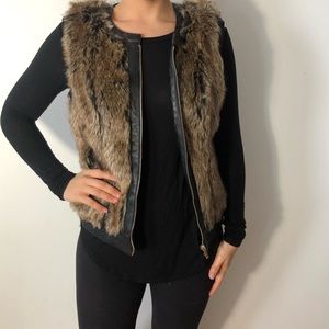 Faux fur very with faux leather and zipper.